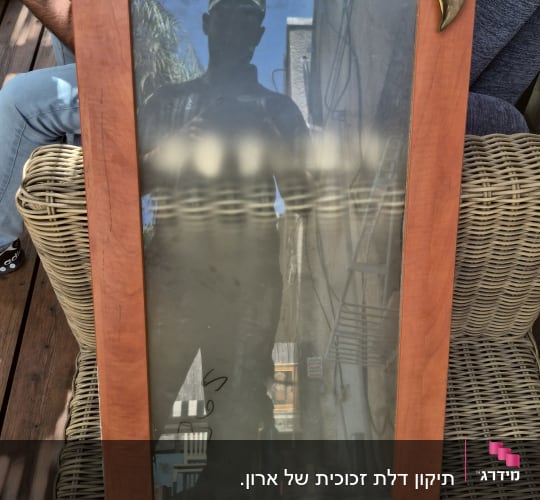 מסגרת עץ עם זכוכית על כיסא קש